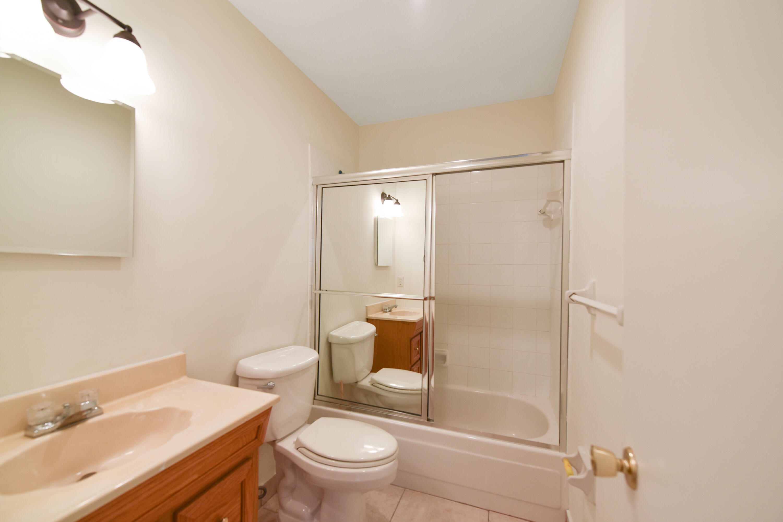 298 Southwest 6th Street, Unit 110 Boca Raton, FL 33432 - Photo 18 of 27 a bathroom with a sink a toilet and shower