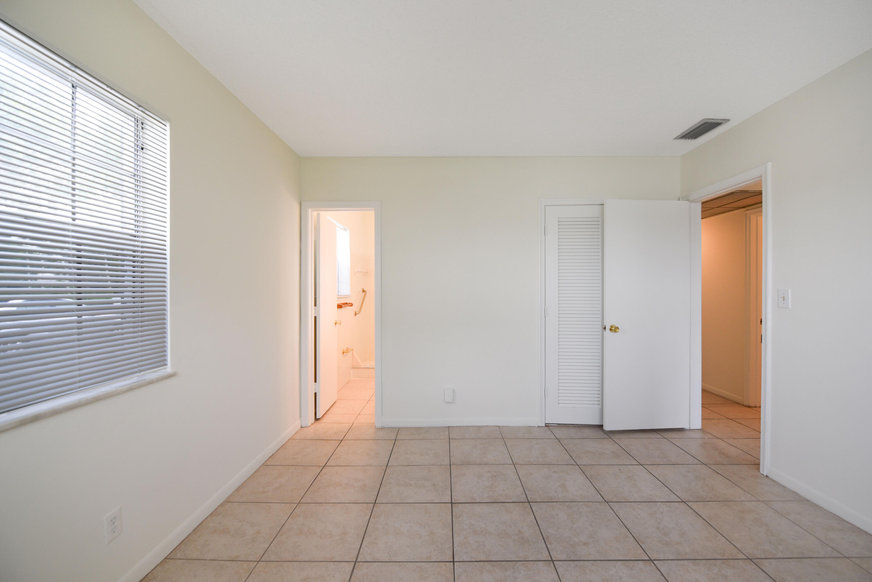 298 Southwest 6th Street, Unit 110 Boca Raton, FL 33432 - Photo 19 of 27 a view of an empty room and window