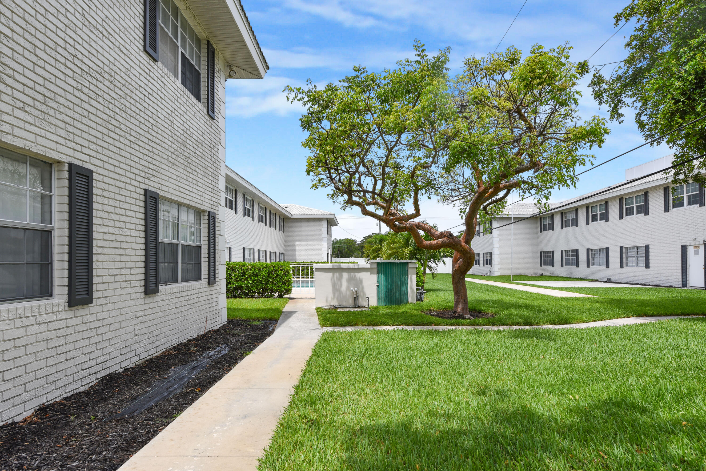 298 Southwest 6th Street, Unit 110 Boca Raton, FL 33432 - Photo 24 of 27 a front view of a house with a garden