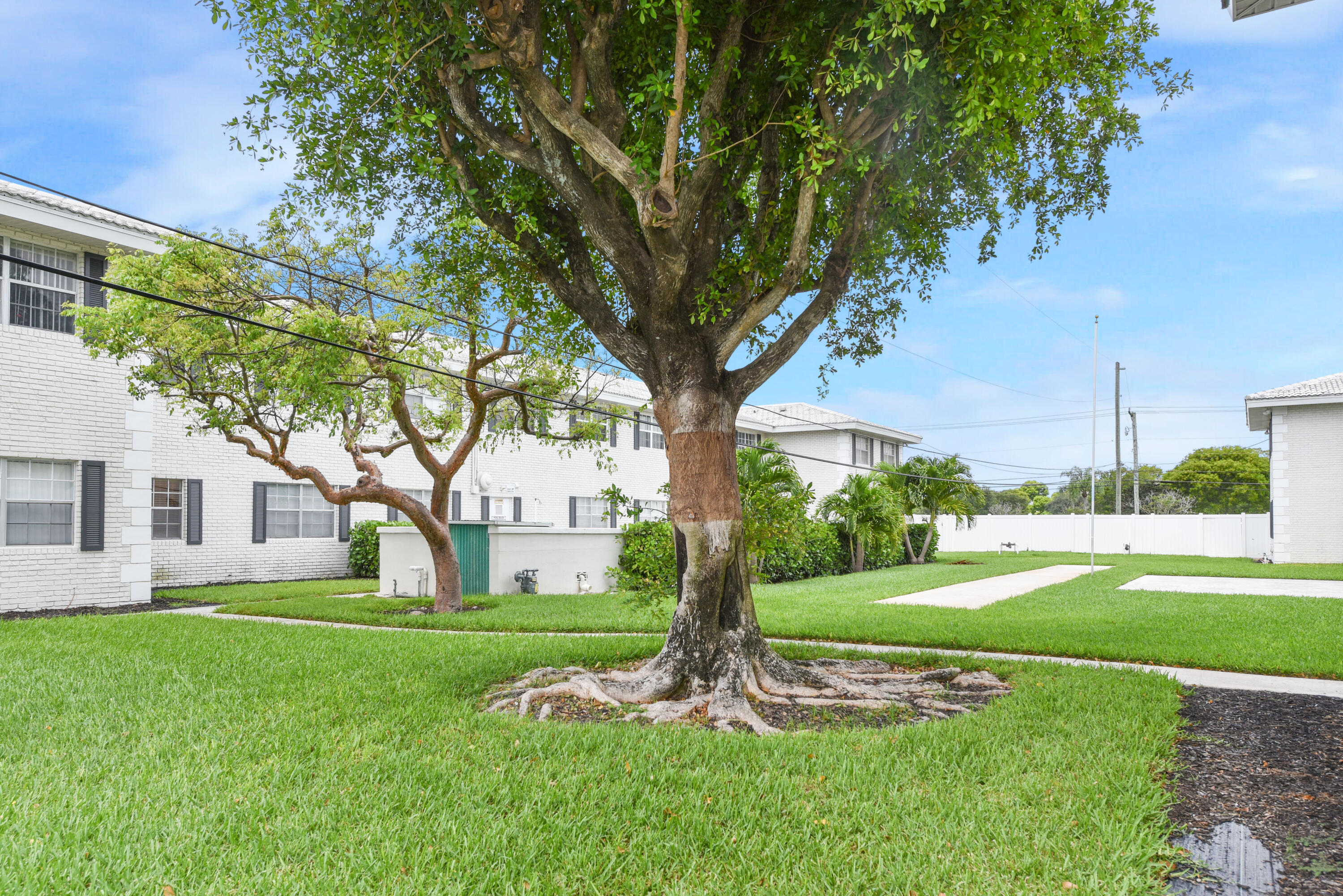 298 Southwest 6th Street, Unit 110 Boca Raton, FL 33432 - Photo 26 of 27 a view of a house with a big yard