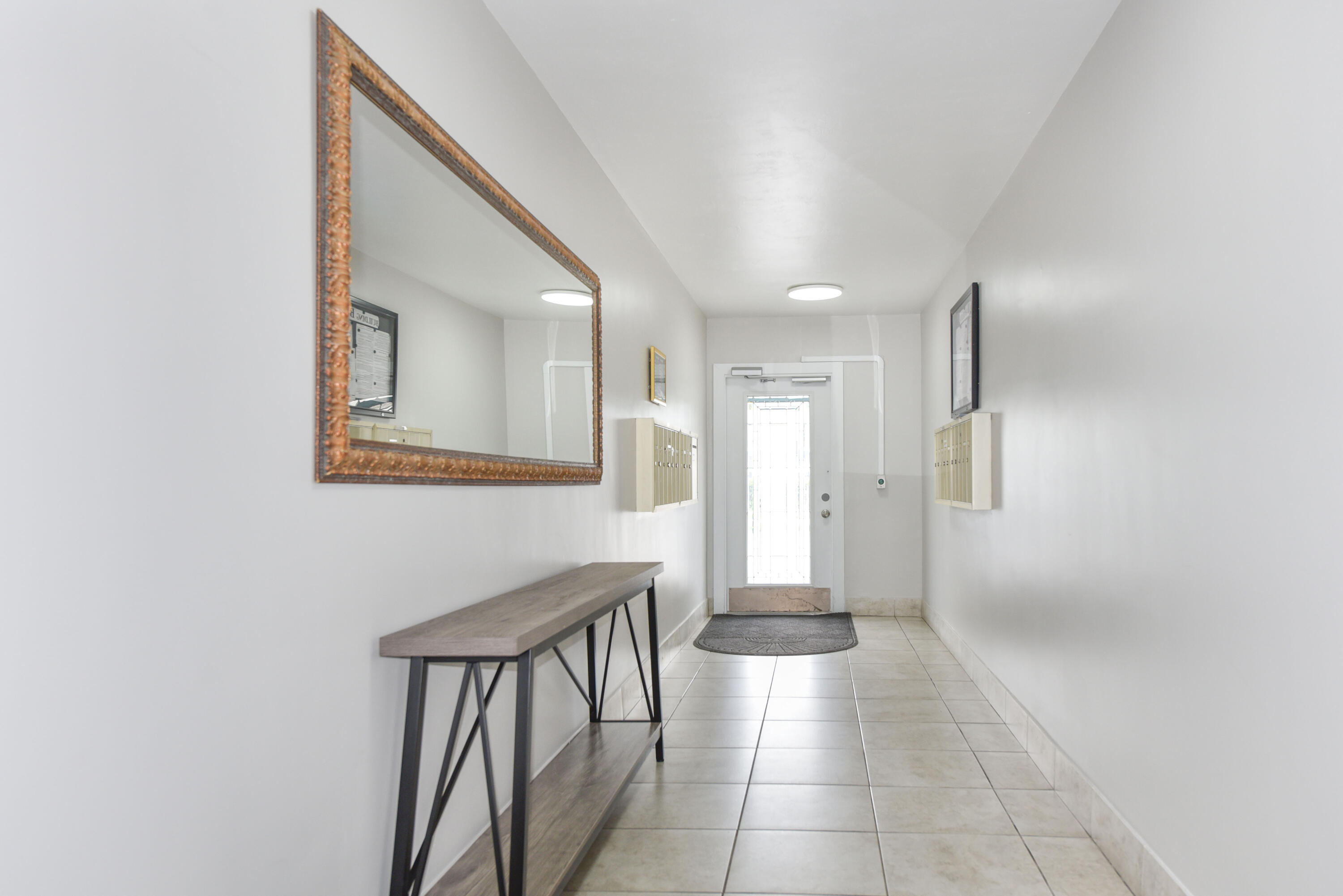 298 Southwest 6th Street, Unit 110 Boca Raton, FL 33432 - Photo 27 of 27 a view of a hallway with windows