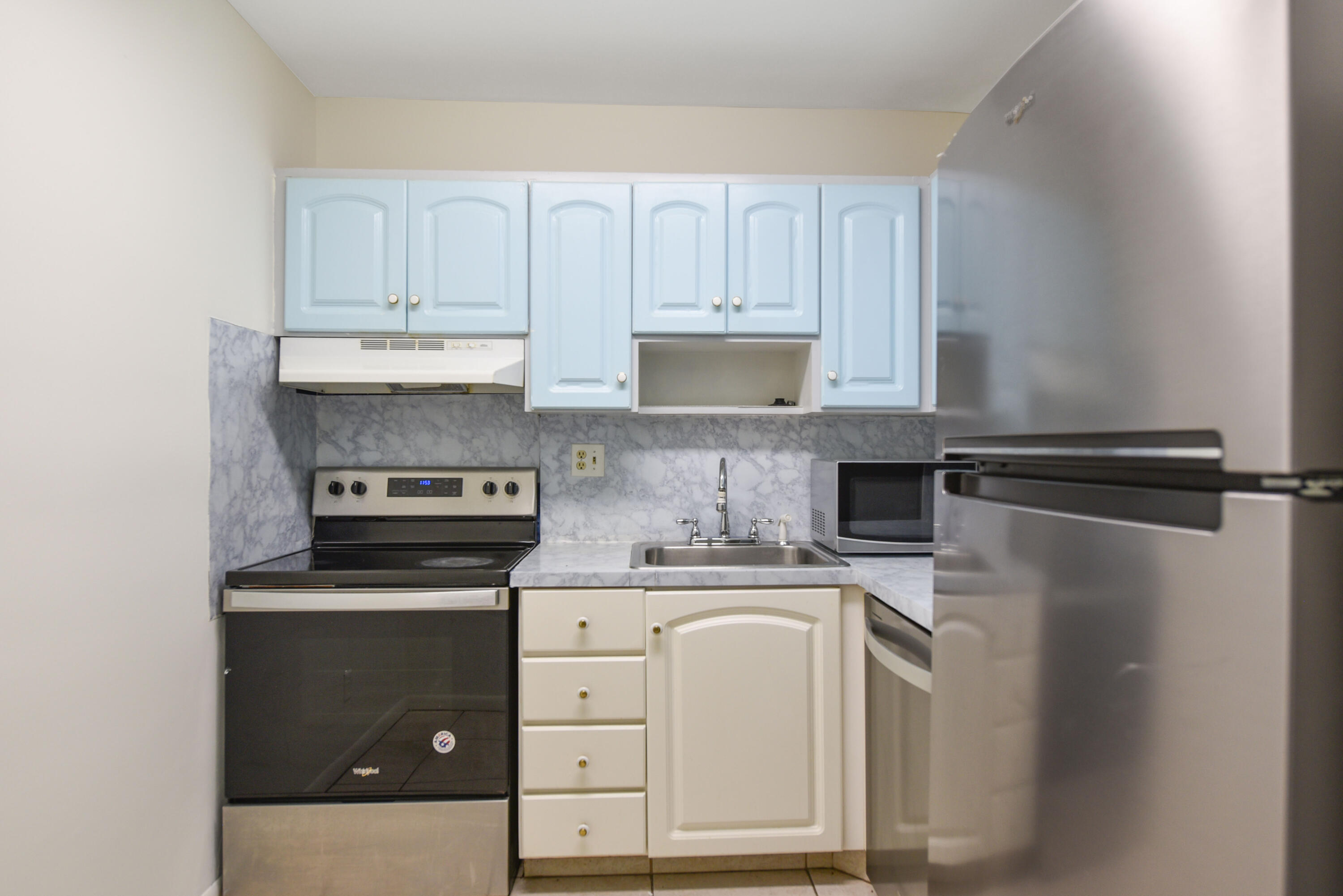 298 Southwest 6th Street, Unit 110 Boca Raton, FL 33432 - Photo 10 of 27 a kitchen with white cabinets and appliances