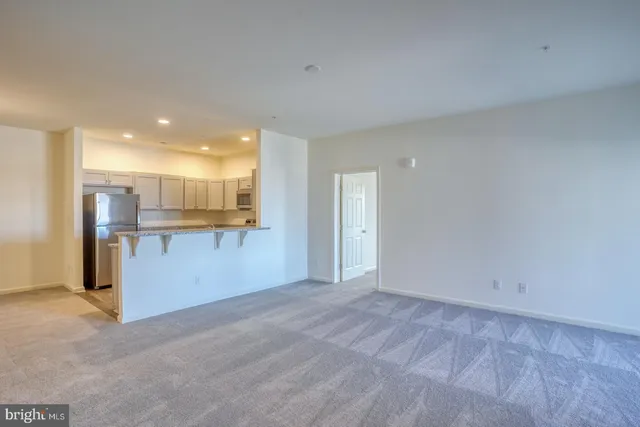 a view of kitchen with refrigerator