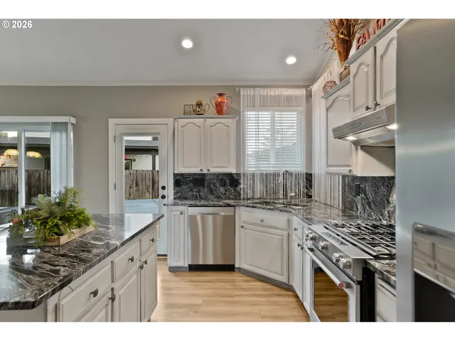 a living room with lots of furniture and chandelier
