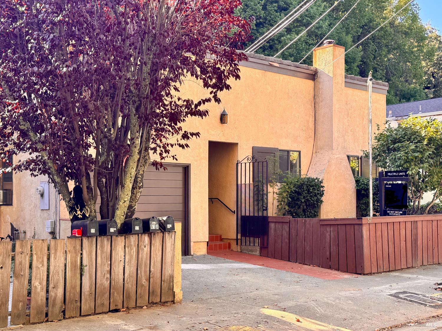 55-61 Park Road Fairfax, CA 94930 - Photo 2 of 26 a view of a house with wooden fence next to a road
