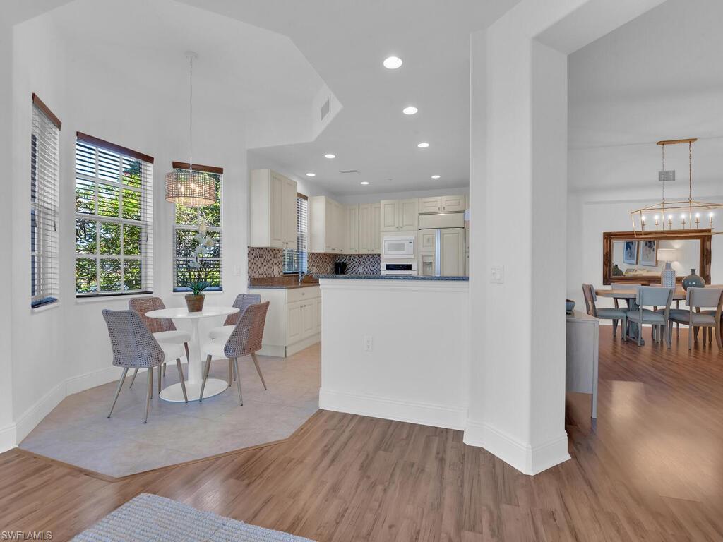 2710 Callista Court, Unit 104 Naples, FL 34114 - Photo 12 of 43 a view of a dining room with furniture and wooden floor
