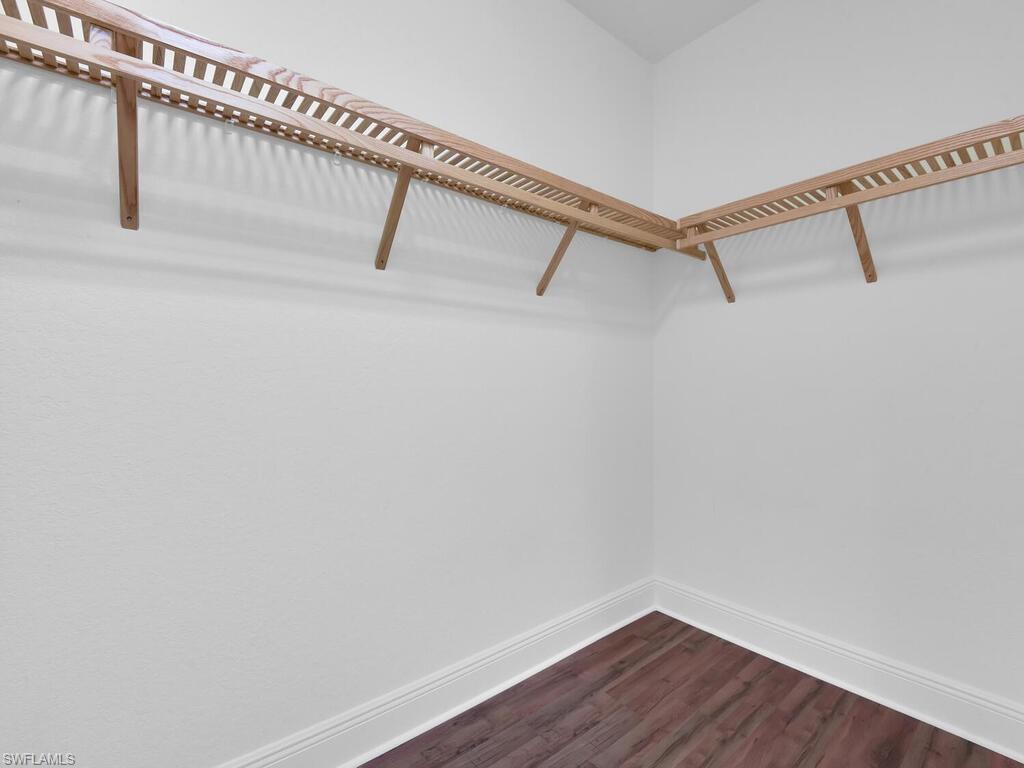 2710 Callista Court, Unit 104 Naples, FL 34114 - Photo 30 of 43 a view of a room with racks on the wall