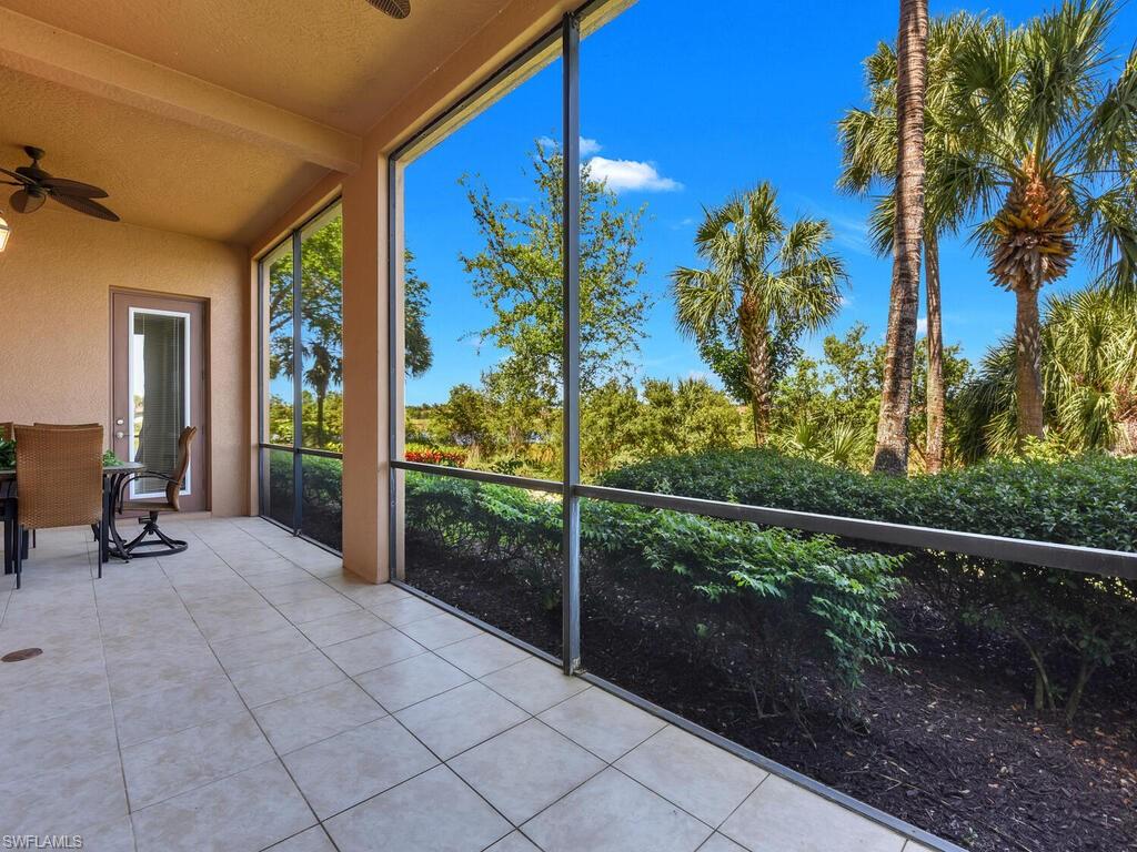 2710 Callista Court, Unit 104 Naples, FL 34114 - Photo 33 of 43 a view of a room with a floor to ceiling window and potted plants