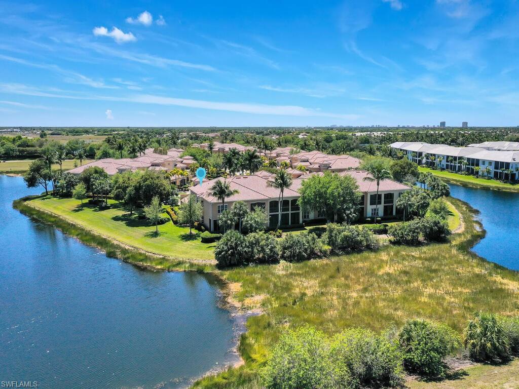 2710 Callista Court, Unit 104 Naples, FL 34114 - Photo 41 of 43 a view of a lake with houses in the back