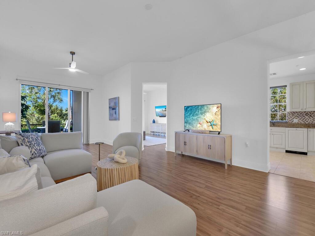 2710 Callista Court, Unit 104 Naples, FL 34114 - Photo 7 of 43 a living room with furniture and a flat screen tv