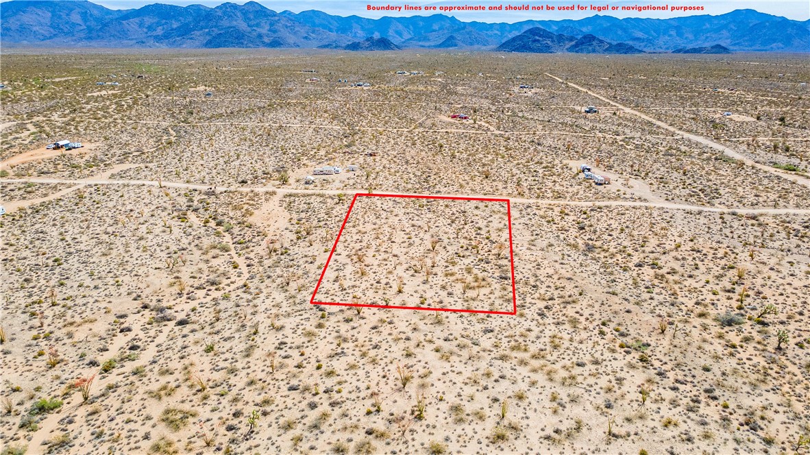 Lot 7 South Sherry Road Yucca, AZ 86438 - Photo 3 of 20 Aerial view of sparsely populated area featuring mountains, a desert landscape, and property parcel outlined
