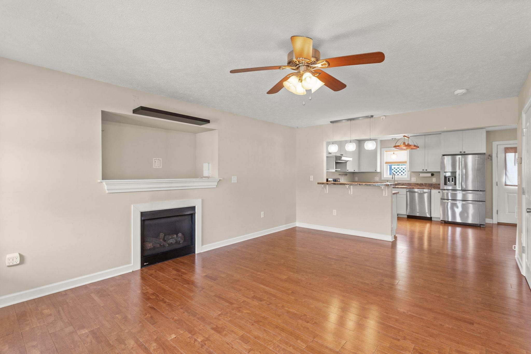 315 Rustic Avenue Broadway, VA 22815 - Photo 4 of 19 with gas fireplace and open to kitchen with breakfast bar