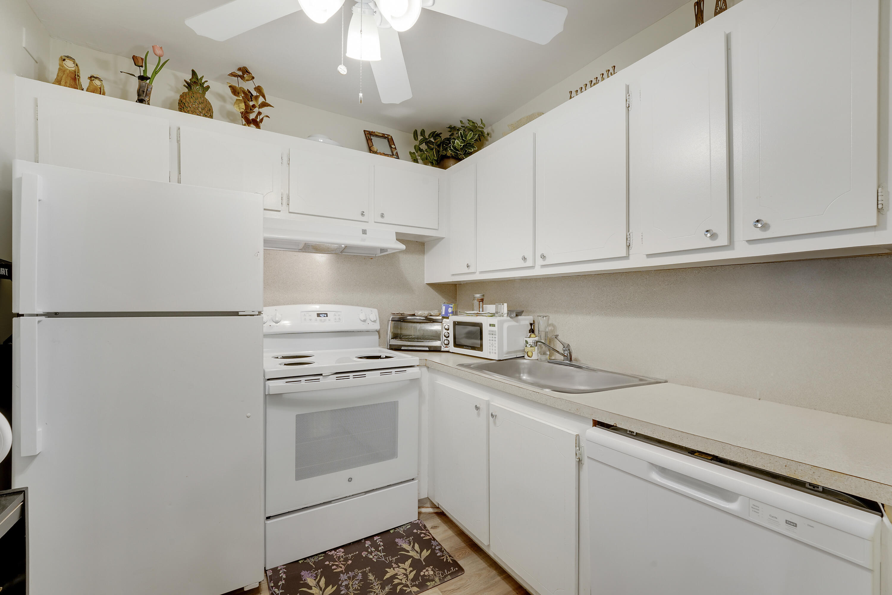146 Mansfield D Boca Raton, FL 33434 - Photo 7 of 12 a kitchen with appliances cabinets and a sink