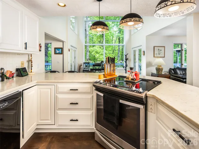 a kitchen with a stove and a wooden floor