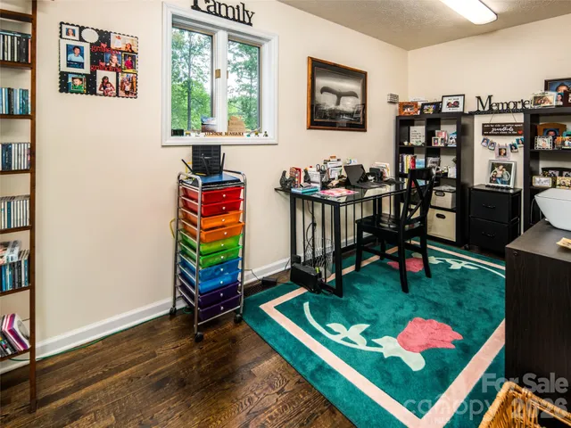 a living room with furniture lamp and book shelf