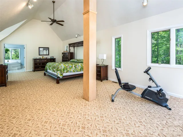 a living room with furniture gym equipment and a large window