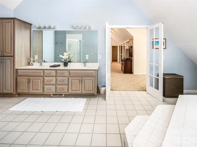 a large bathroom with a sink and mirror
