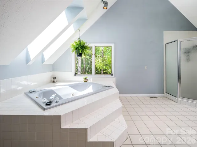 a bathroom with a tub sink and mirror