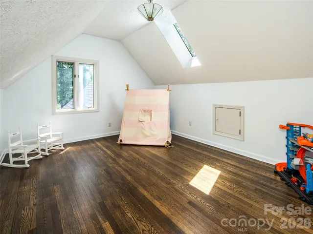 a view of a room with wooden floor and window