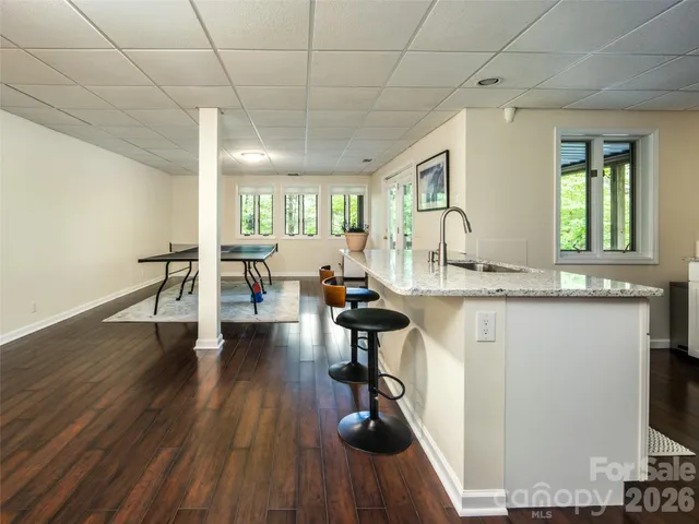 a living room with furniture a wooden floor and a flat screen tv