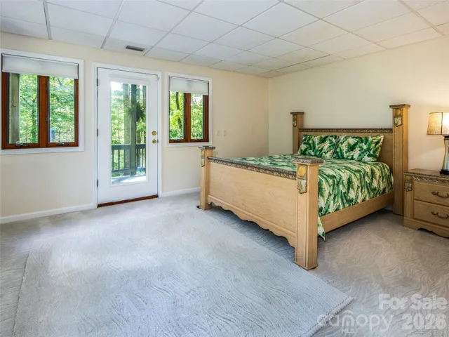 a bedroom with a bed table and window