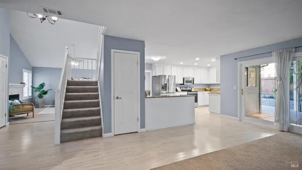 a view of kitchen with wooden floor and electronic appliances