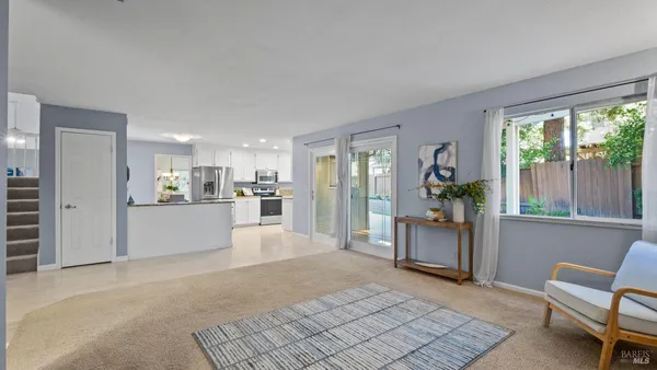 a bathroom with a sink a toilet a shower curtain and a mirror