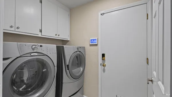 a bedroom with a bed chandelier and window