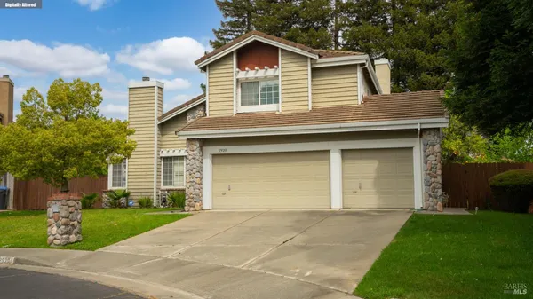 a front view of a house with a garden and plants