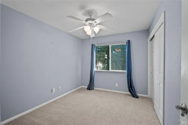 a bathroom with a toilet sink vanity granite and shower
