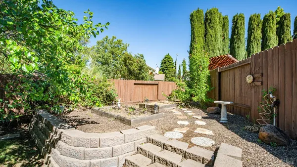 a view of house with backyard and garden