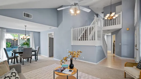 a living room with furniture and a chandelier