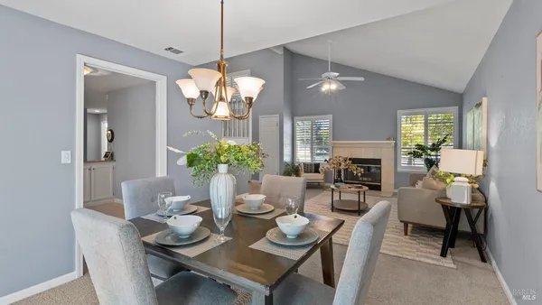 a view of a dining room with furniture and chandelier