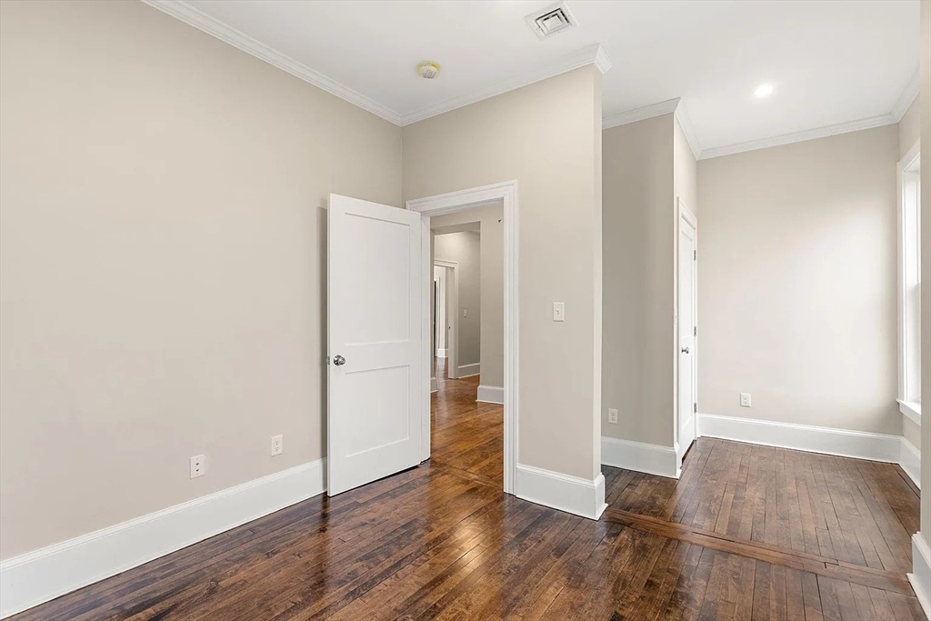 10 King Street, Unit 2 Boston, MA 02122 - Photo 12 of 17 an empty room with wooden floor & windows