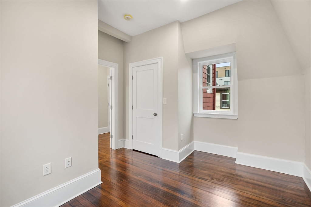10 King Street, Unit 2 Boston, MA 02122 - Photo 13 of 17 an empty room with wooden floor and windows