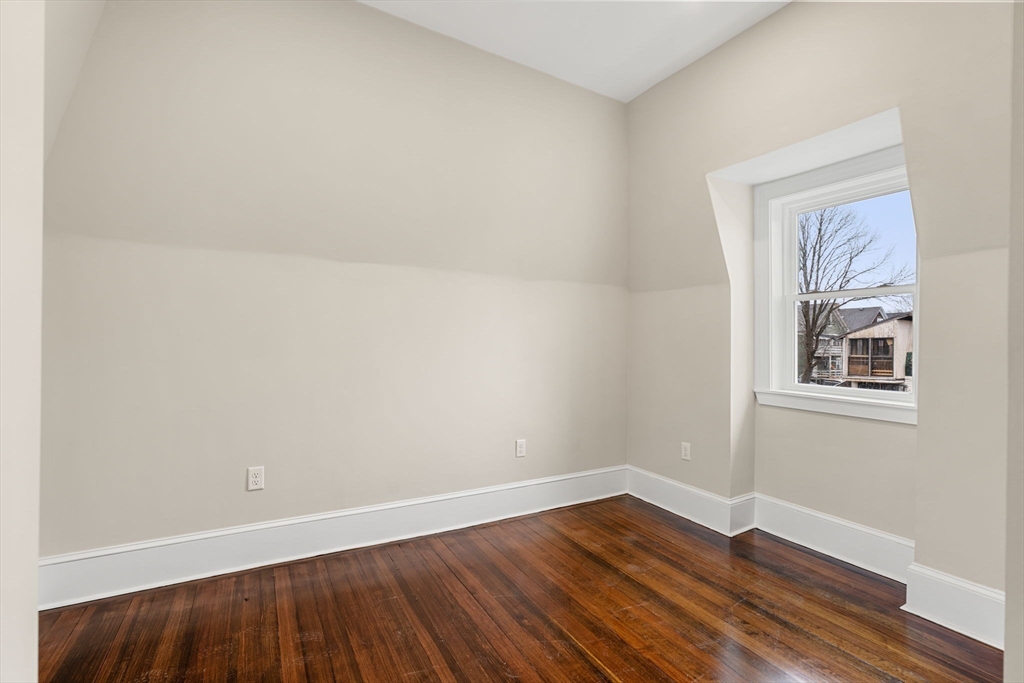 10 King Street, Unit 2 Boston, MA 02122 - Photo 14 of 17 an empty room with wooden floor and windows