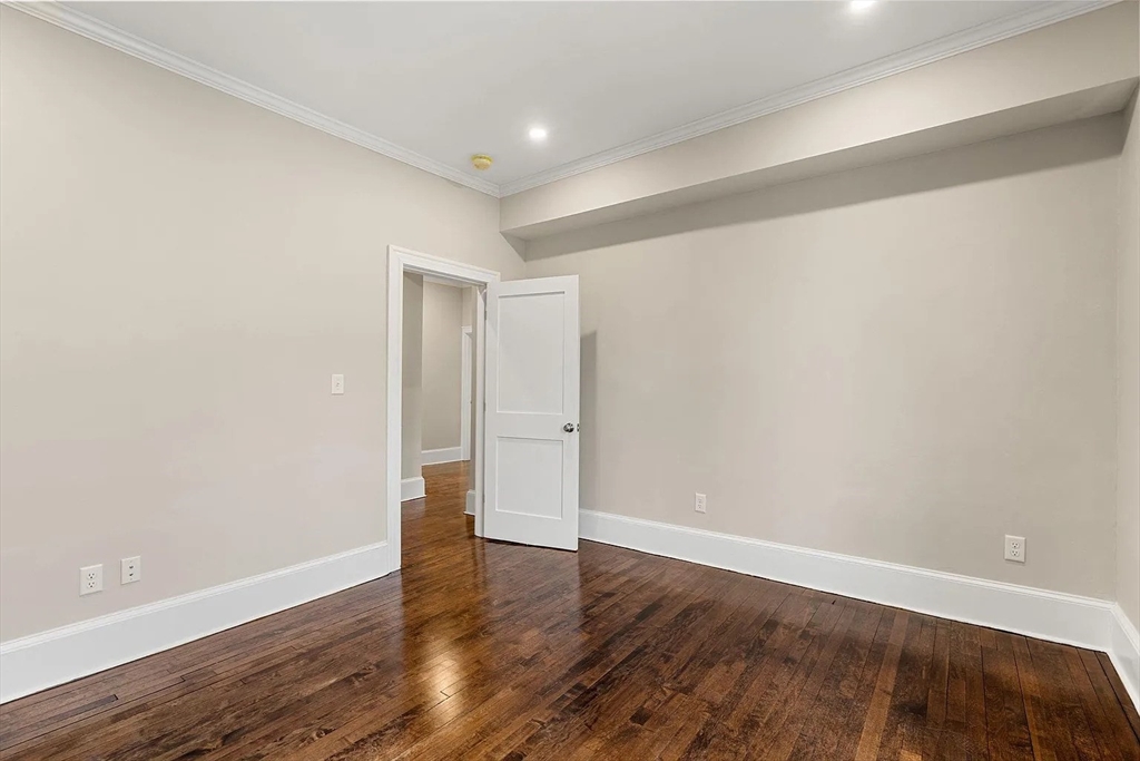 10 King Street, Unit 2 Boston, MA 02122 - Photo 15 of 17 a view of an empty room with wooden floor