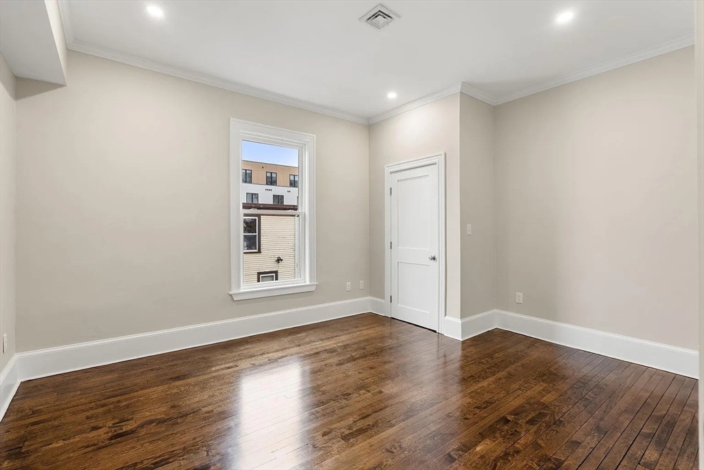 10 King Street, Unit 2 Boston, MA 02122 - Photo 16 of 17 a view of an empty room with wooden floor and a window