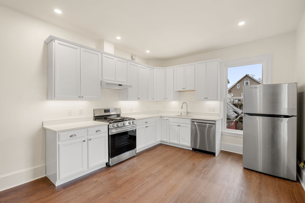 10 King Street, Unit 2 Boston, MA 02122 - Photo 5 of 17 a kitchen with a refrigerator sink and wooden floor