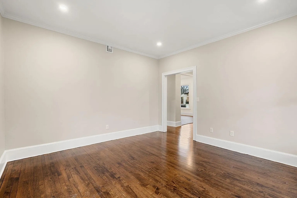 10 King Street, Unit 2 Boston, MA 02122 - Photo 8 of 17 a view of an empty room with wooden floor and windows