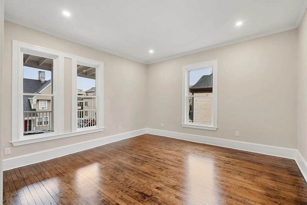 10 King Street, Unit 2 Boston, MA 02122 - Photo 9 of 17 a view of an empty room with wooden floor and a window