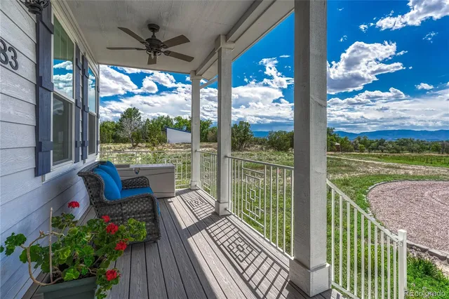 a balcony with furniture and garden view