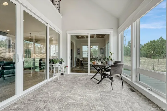 a work room with a large window and furniture