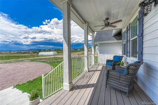 a view of a porch with furniture and wooden floor