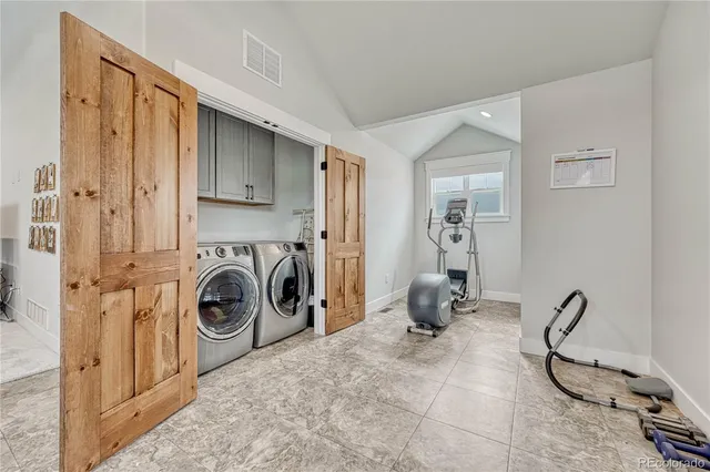 a room with gym equipment and a large mirror