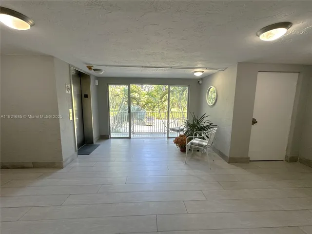 a view of livingroom with furniture and floor to ceiling window