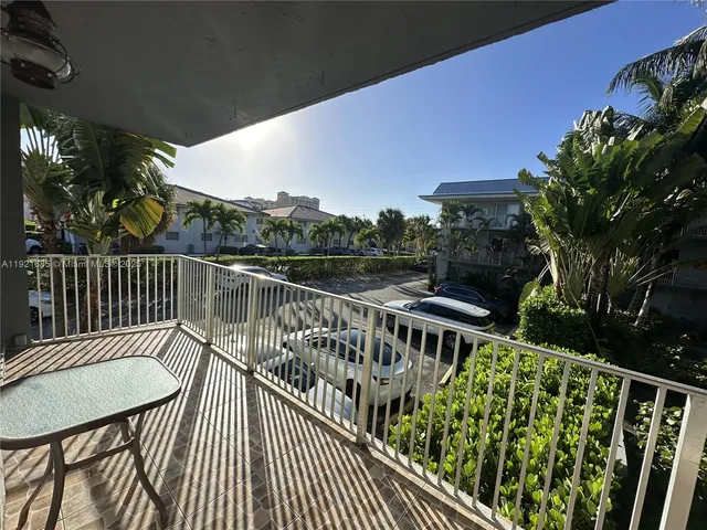 a view of a balcony with wooden floor
