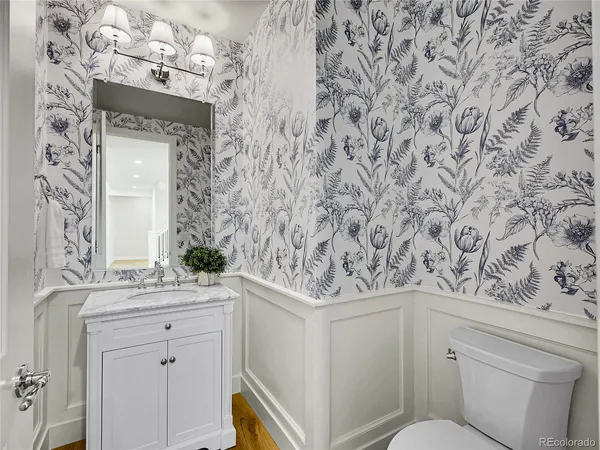 a bathroom with a sink and mirror with toilet