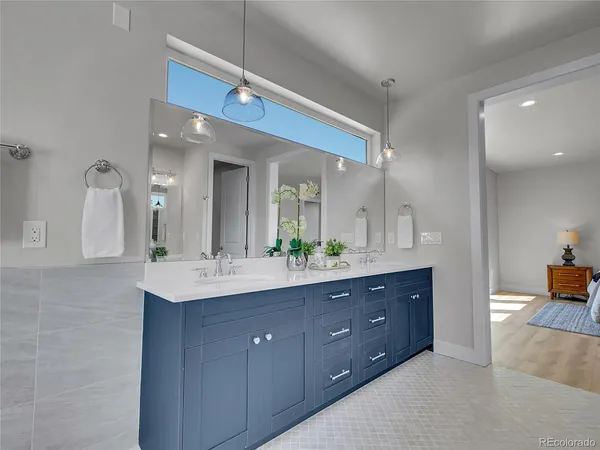 a bathroom with a double vanity sink and a mirror