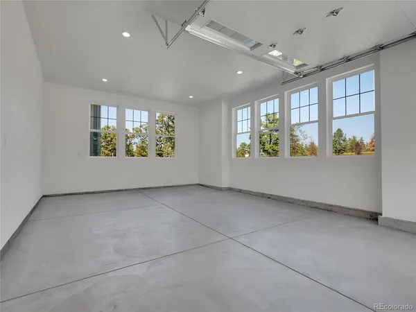 a view of backyard with large windows and wooden floor